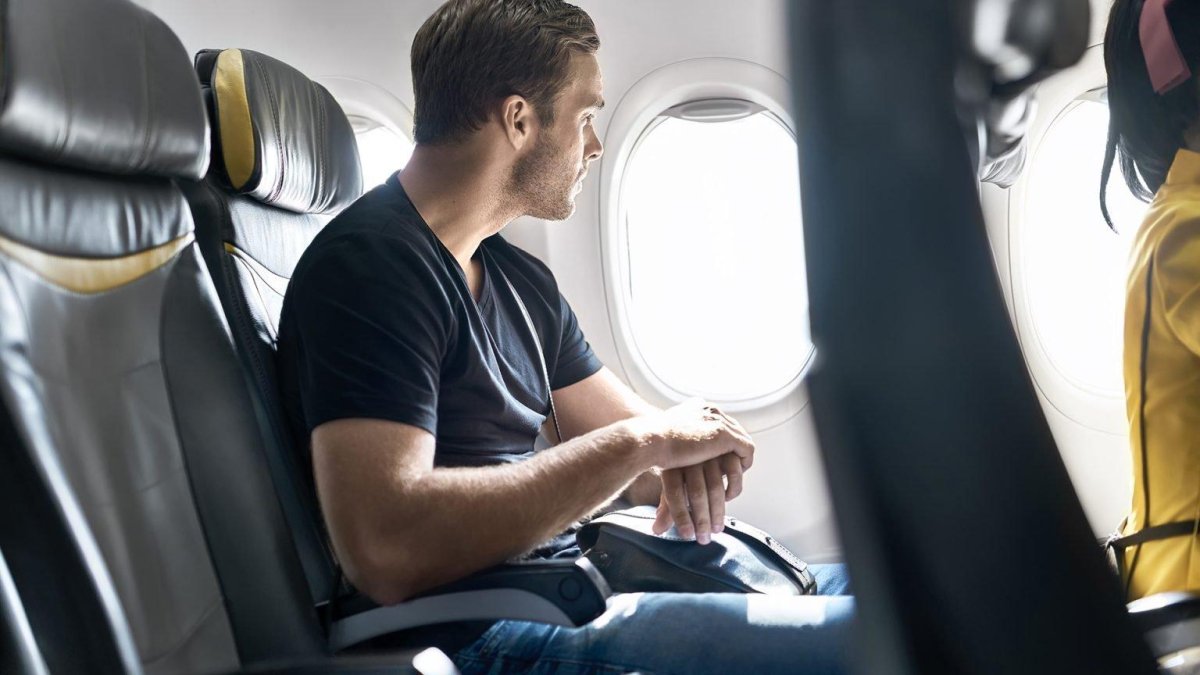 Мужчина в кресле самолета