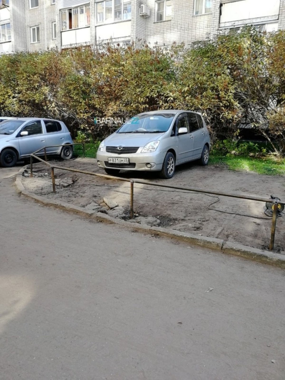 Припаркованный на заборе автомобиль