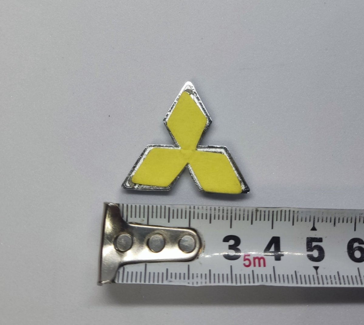 Красная эмблема Митсубиси